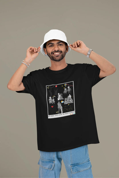 First front view of a male model wearing a black oversized t-shirt featuring a design that represents cherished memories, inspired by Ed Sheeran's "Photograph."