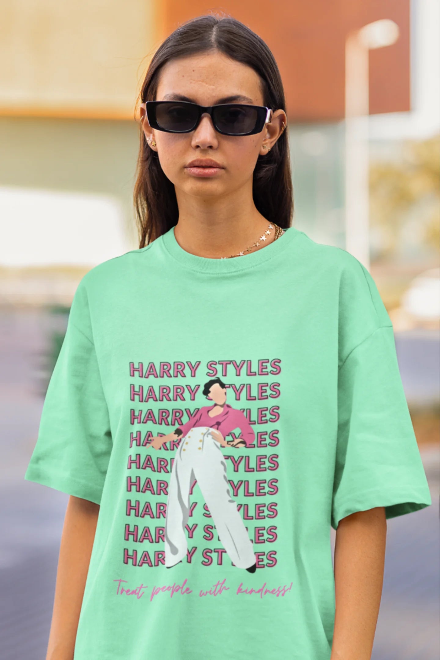 First image of female model wearing mint green oversized t-shirt inspired by Harry Styles, featuring the 'Treat People with Kindness' mantra from the Fine Line collection.
