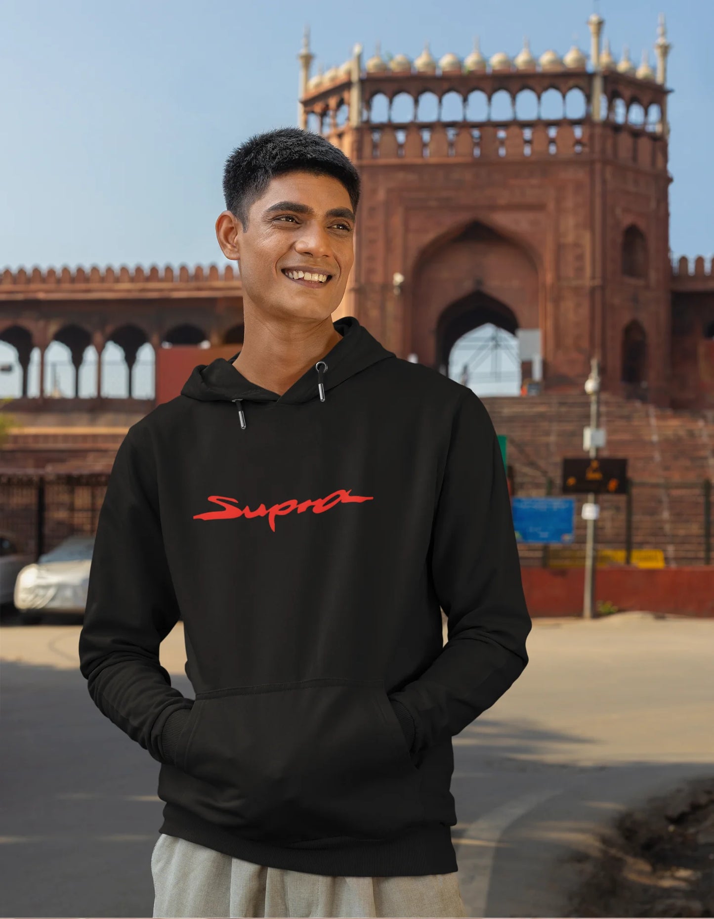 First front view of a male model wearing a black hoodie featuring a Toyota Supra design, exuding speed and power.