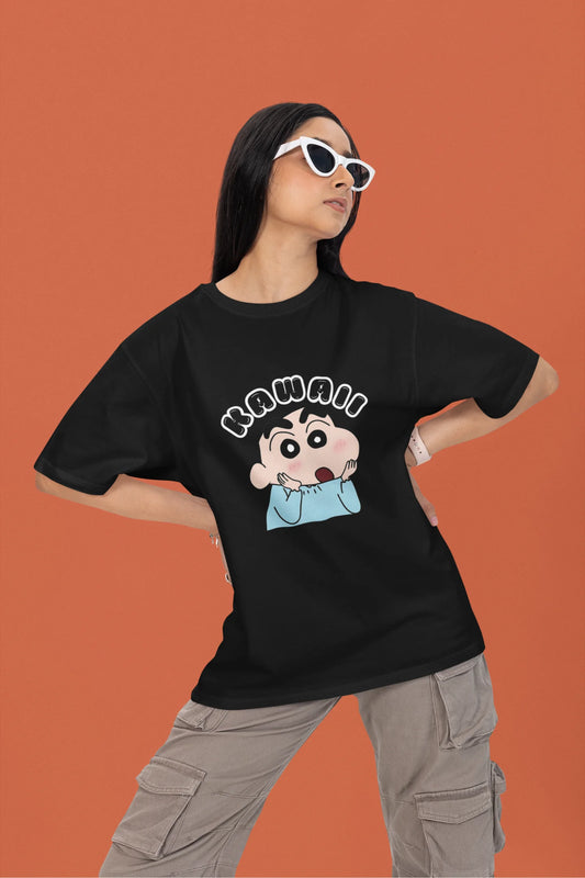 First front view of a female model wearin a black oversized t-shirt featuring Shinchan looking amazed and saying "Kawaii."