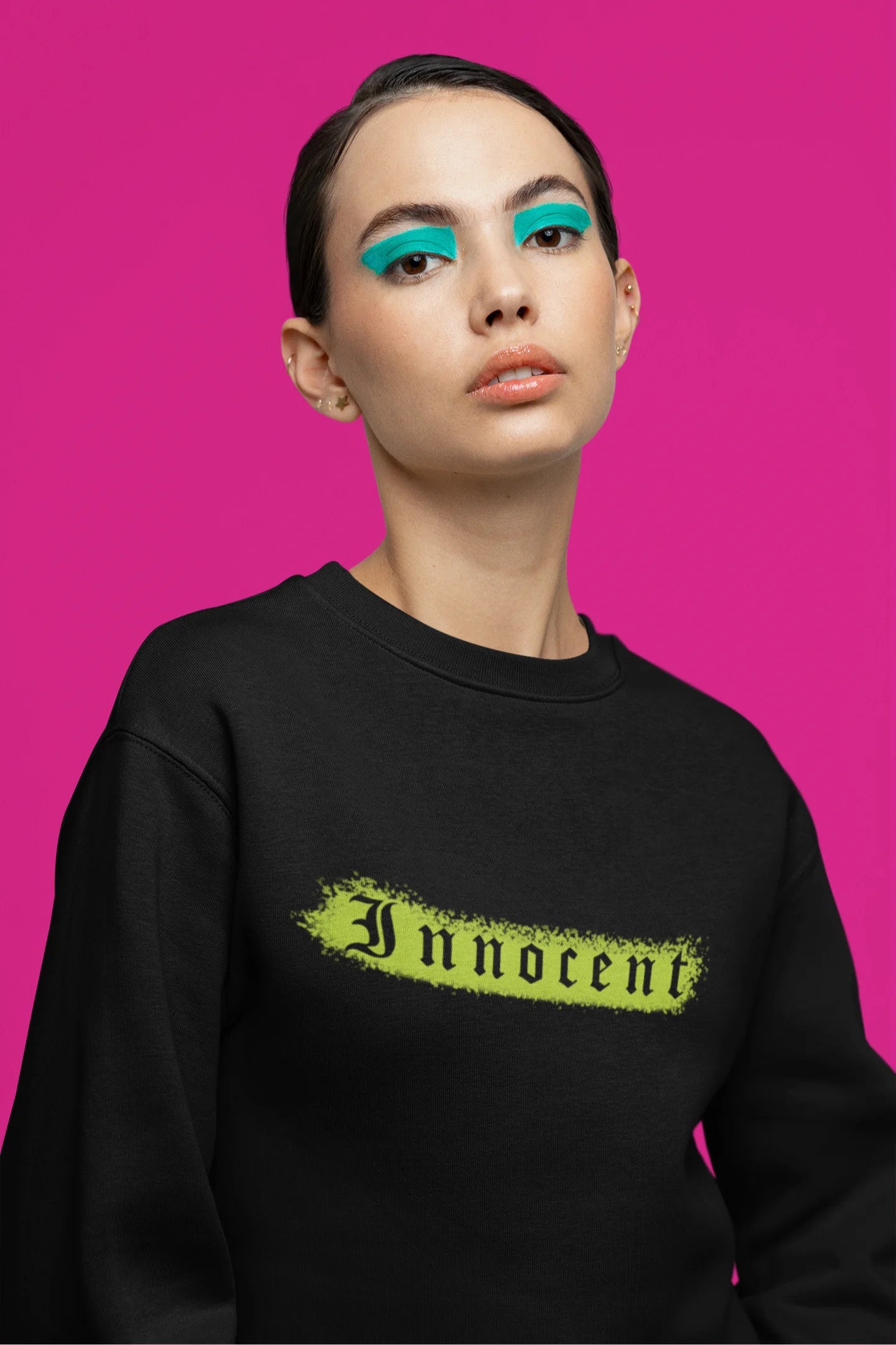 Fourth front view of a female model wearing a black sweatshirt with a contrasting design of a cupid statue and brutalist elements.