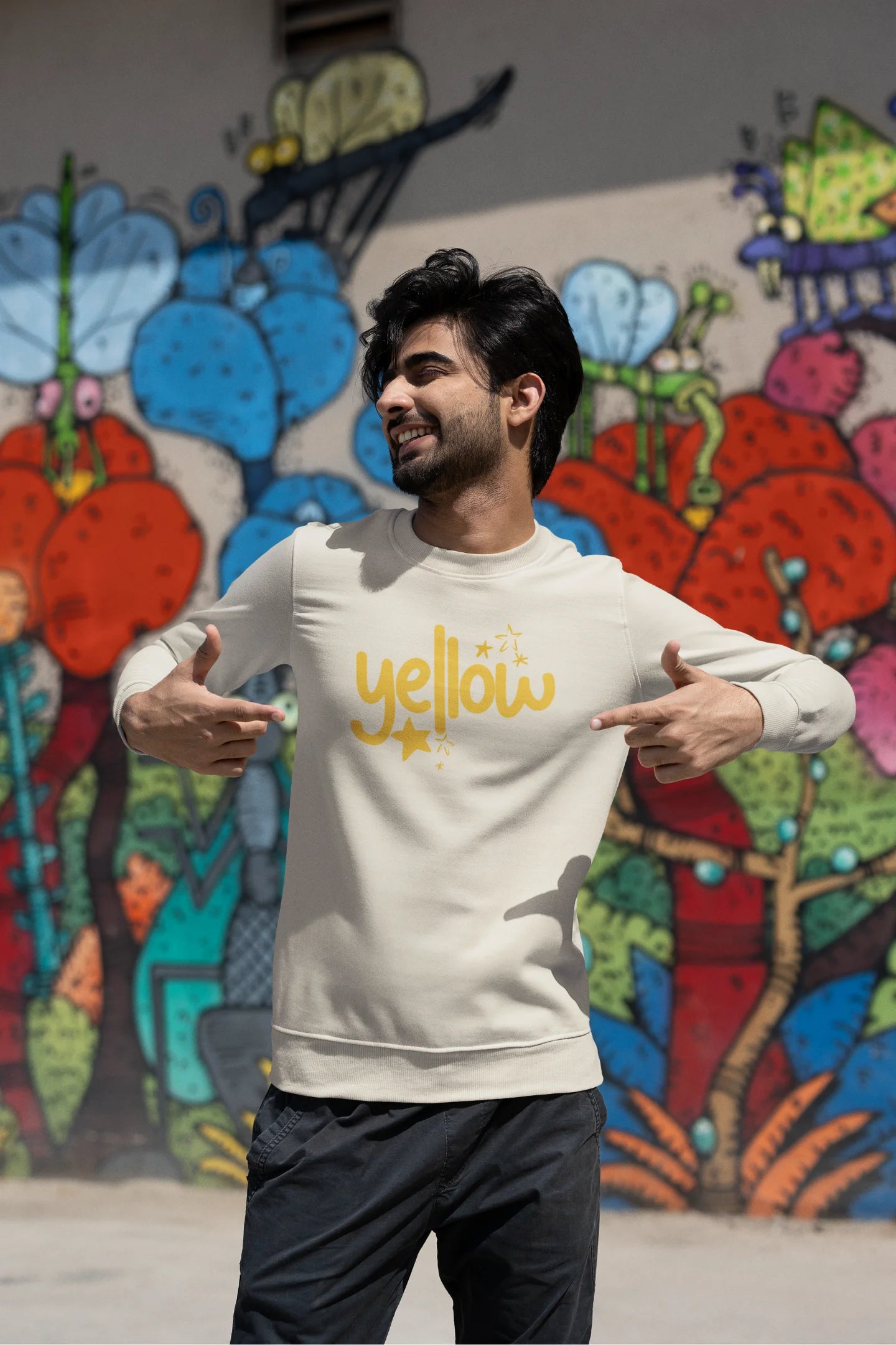 Second front view of a male model wearing a cream sweatshirt with the "Yellow" album artwork by Coldplay.
