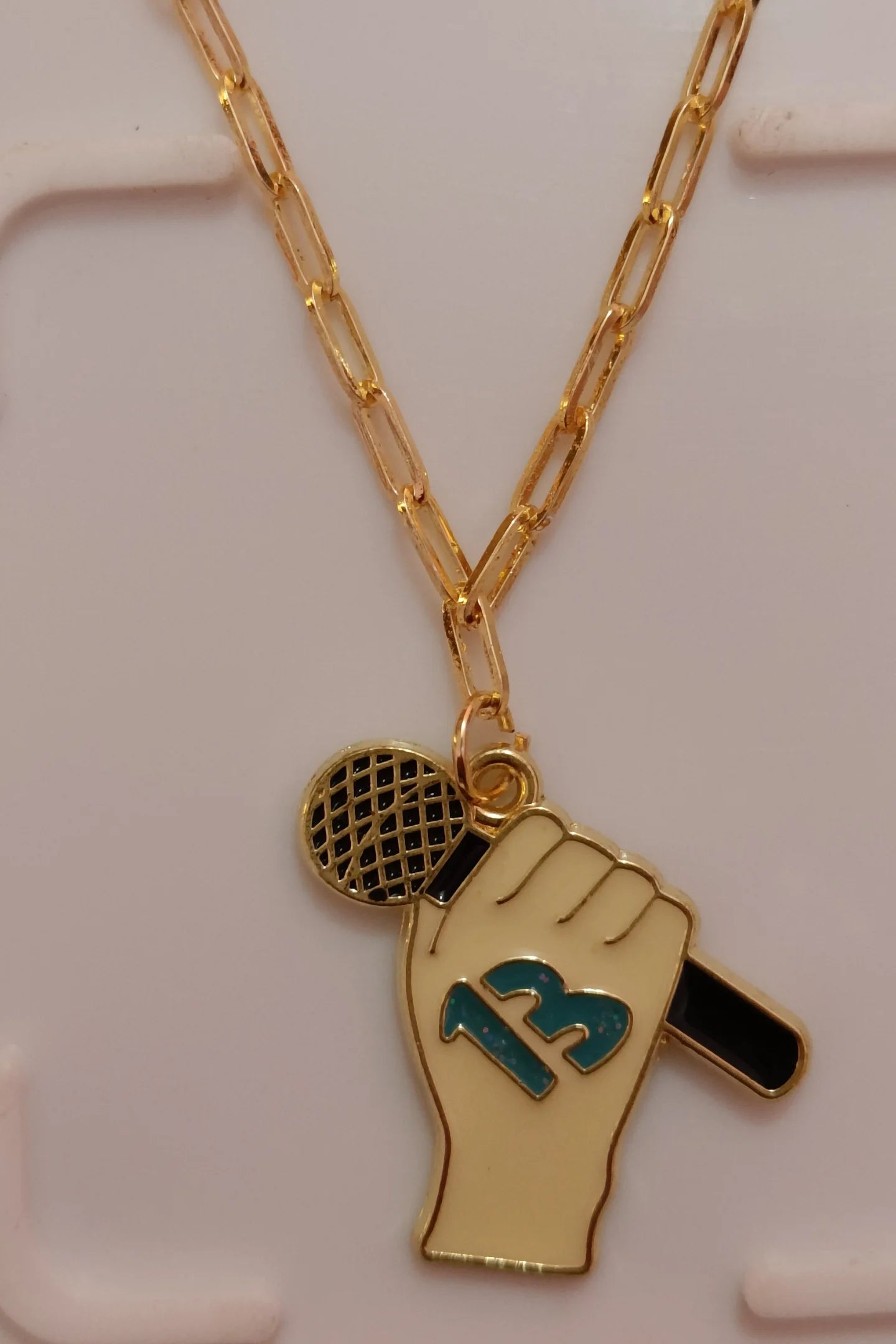 Third image of a taylor swift 13 themed anti tarnish gold chain.