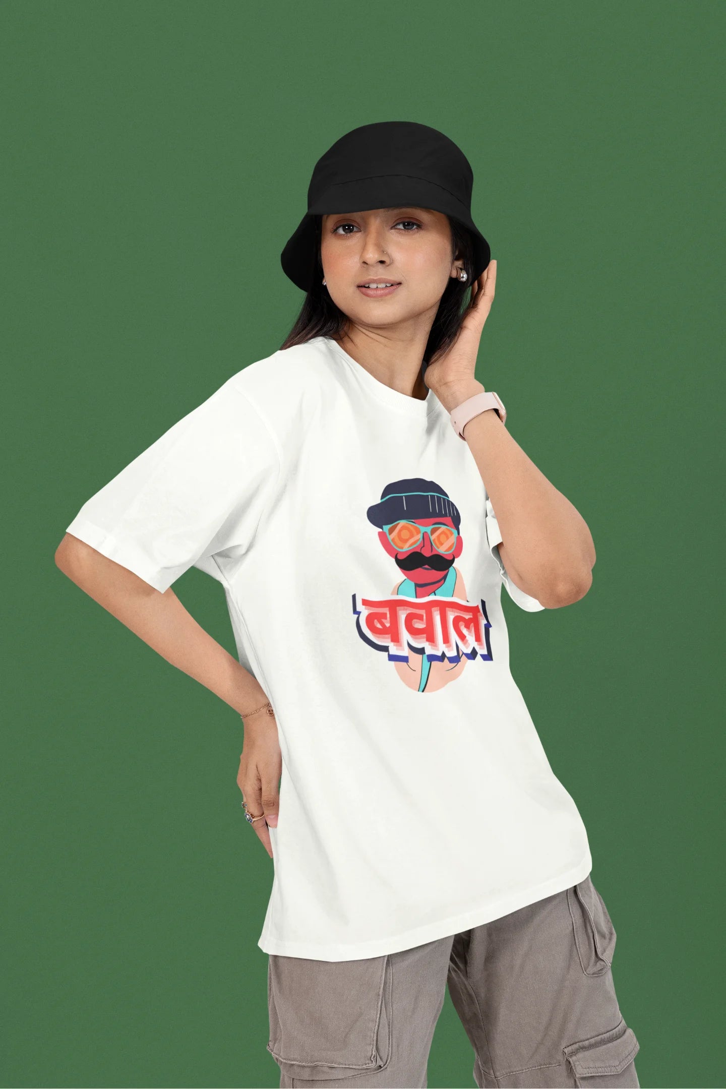 First front view of a female model wearing a off-white oversized t-shirt with "Bawaal" in a stylish Hindi.