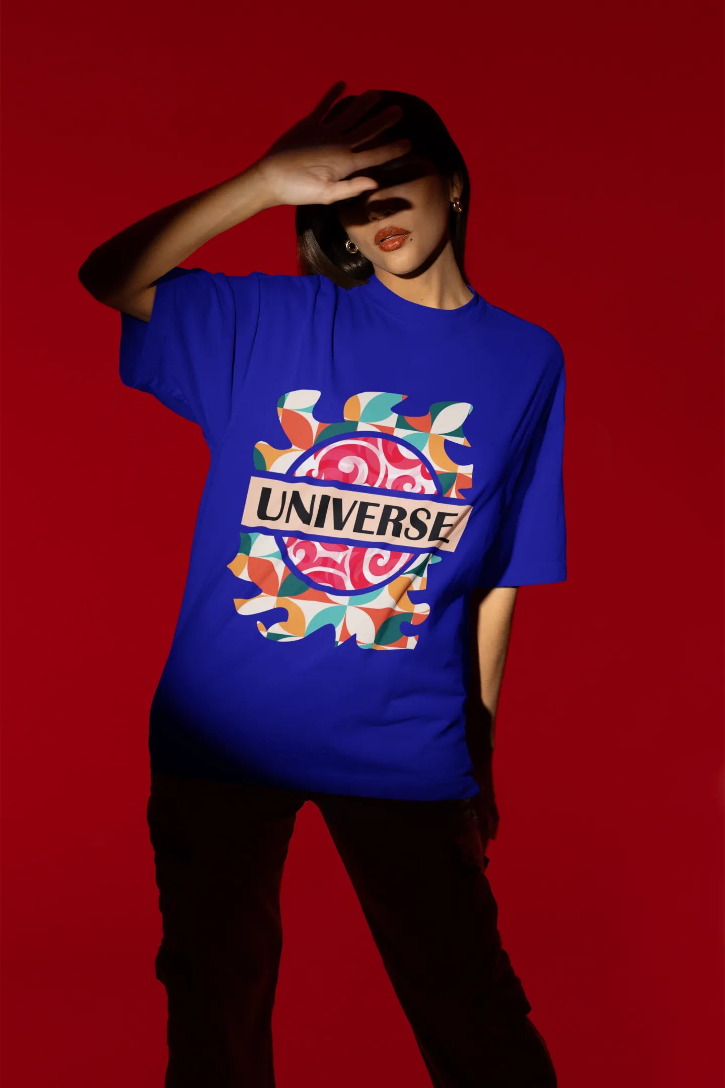 Second front view of a female model wearing an royal blue oversized t-shirt with a cosmic Universe design inspired by Coldplay.