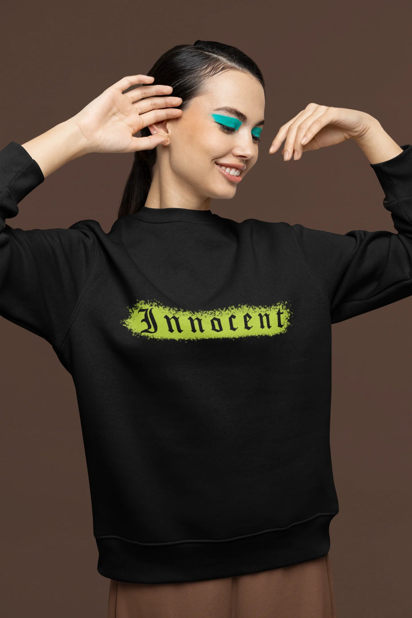First front view of a female model wearing a black sweatshirt with a contrasting design of a cupid statue and brutalist elements.