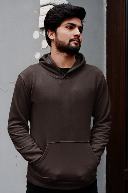 First front view male model wearing a chocolate brown hoodie with a design of a fox and its cub in a traditional Japanese landscape.