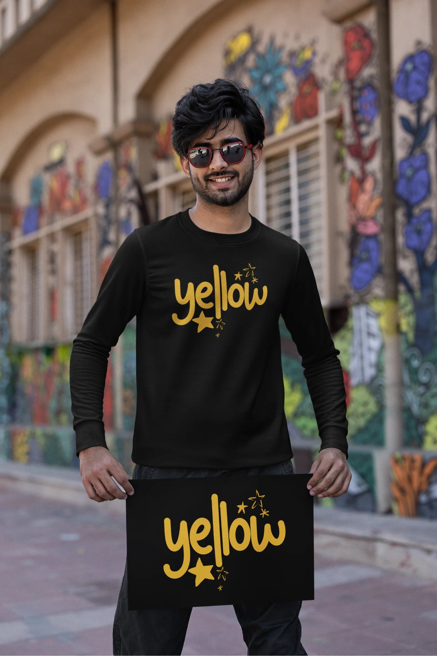 First front view of a male model wearing a black sweatshirt with the "Yellow" album artwork by Coldplay.