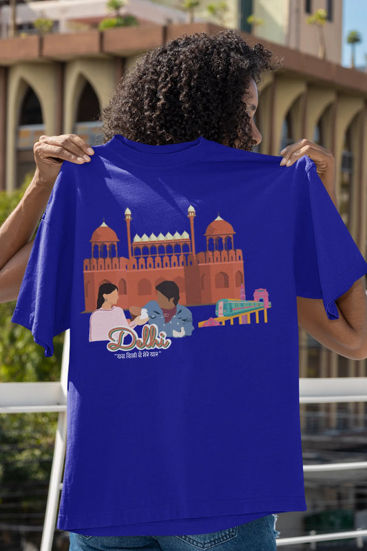 Back view of a royal blue oversized t-shirt featuring a design incorporating the Red Fort and elements representing the city of Delhi, inspired by the Hindi film Delhi 6.