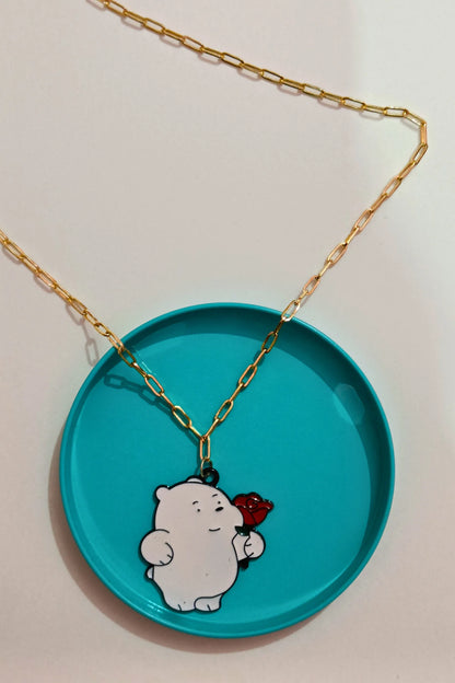 3rd view of a gold chain necklace with a small pendant of Ice Bear from a cartoon, holding a rose.