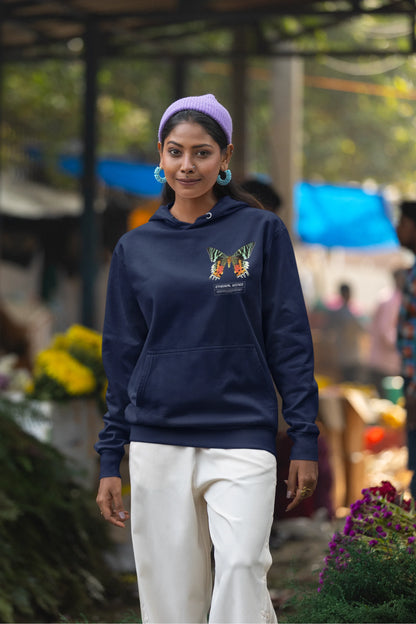 Third front view of a female model wearing a navy blue hoodie with a glowing butterfly design, symbolizing the ethereal beauty of nature.