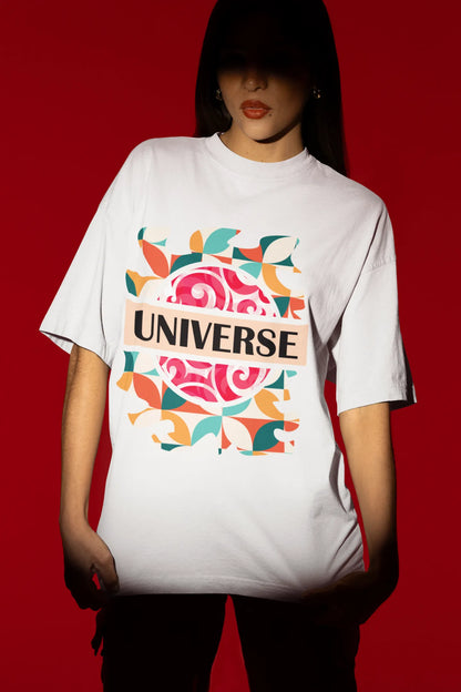 First front view of a female model wearing an off-white oversized t-shirt with a cosmic Universe design inspired by Coldplay.