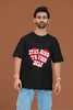 3rd front view of a male model wearing a black oversized t-shirt with the text 