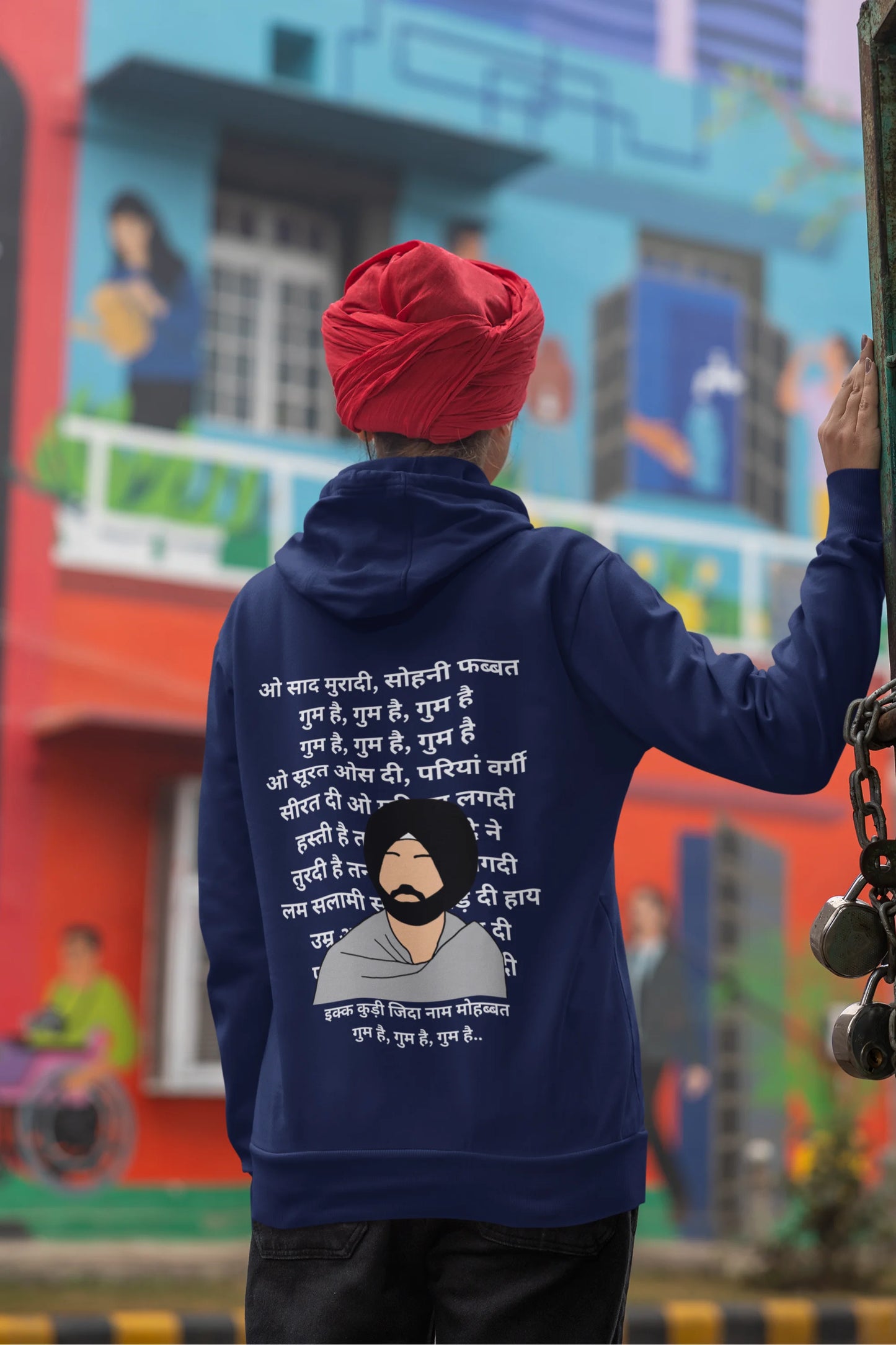 Back view of a female model wearing a royal blue hoodie with a Diljit Dosanjh album cover and song titles.
