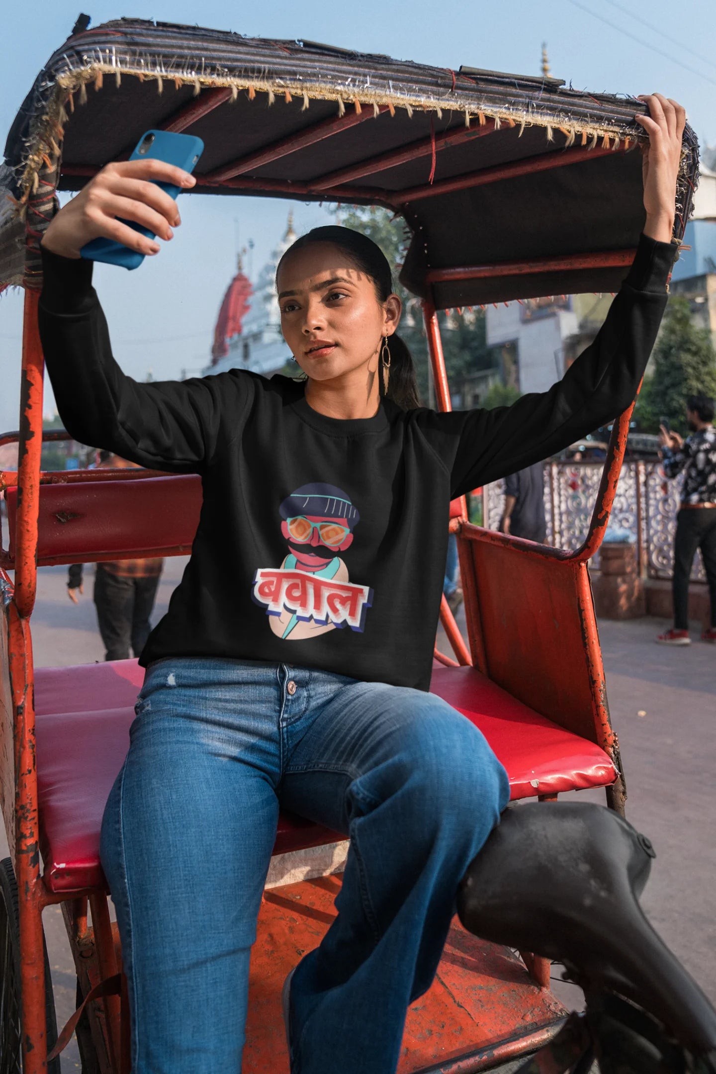 5th front view of a female model wearing a black oversized t-shirt with "Bawaal" in a stylish Hindi.