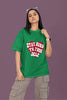 First front view of a female model wearing a forest green oversized t-shirt with the text 