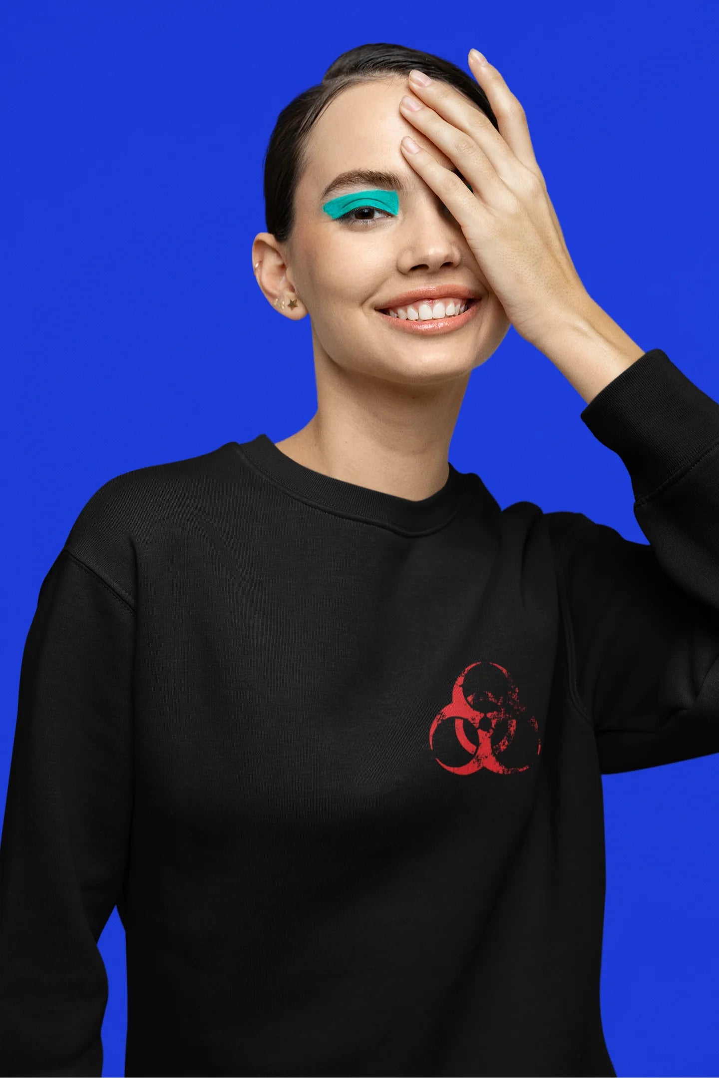 Third front view of a female model wearing a black brutalist sweatshirt with a stylized, concrete-like image of an abstract statue and the word "Experiment" prominently displayed.