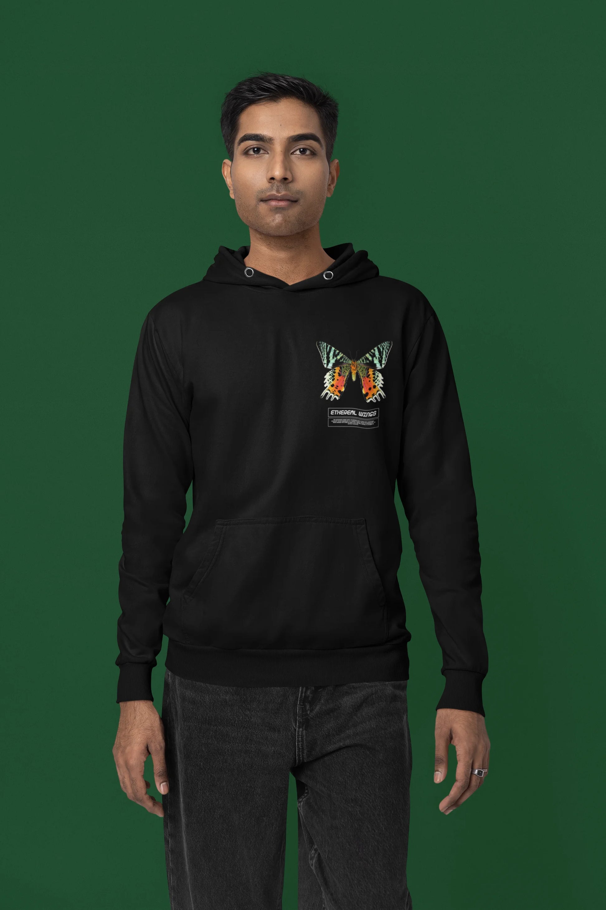 Third front view of a male model wearing a black hoodie with a glowing butterfly design, symbolizing the ethereal beauty of nature.