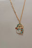 3rd view of a gold chain necklace with a small pendant depicting Shin Chan sleeping.