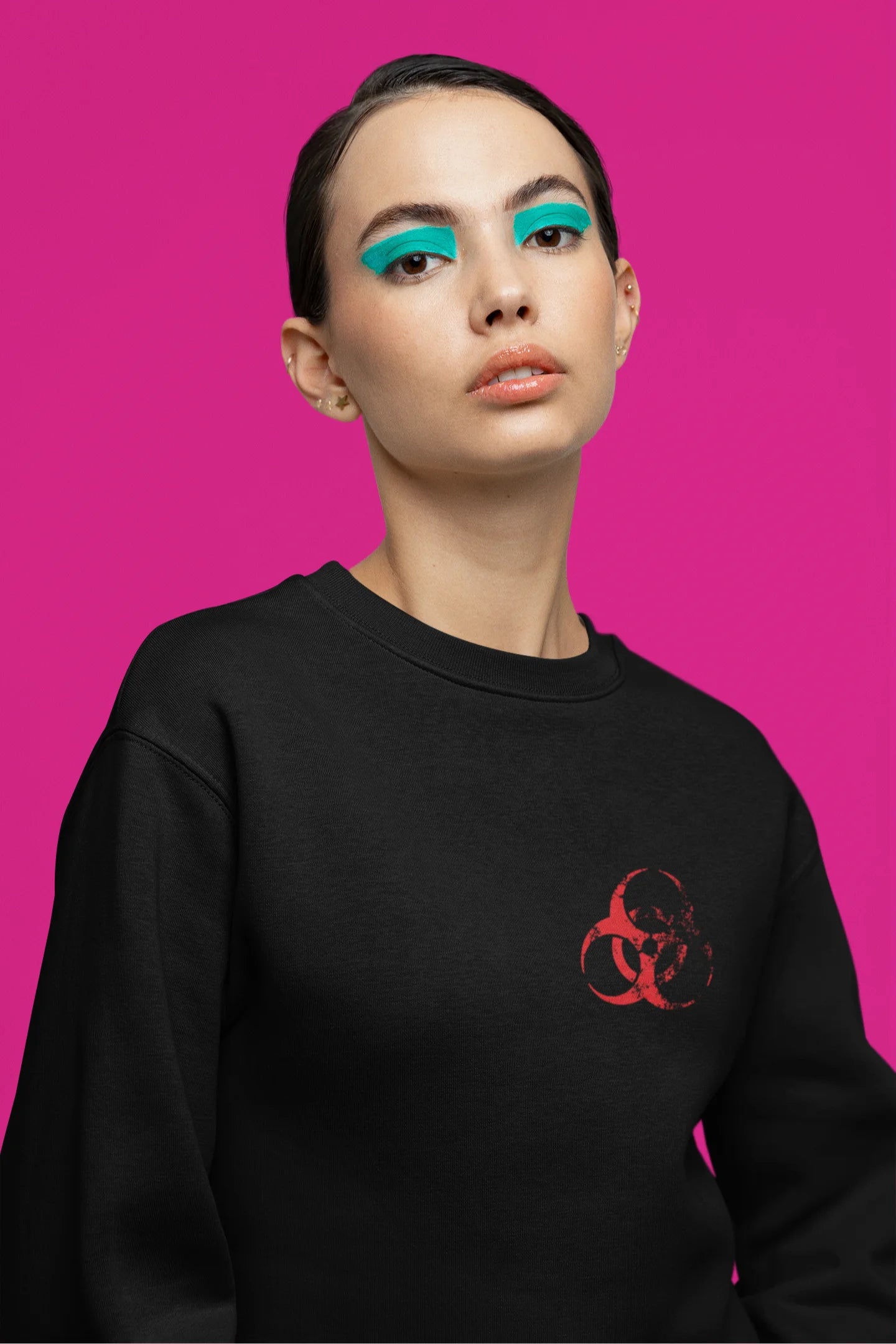 Fifth front view of a female model wearing a black brutalist sweatshirt with a stylized, concrete-like image of an abstract statue and the word "Experiment" prominently displayed.