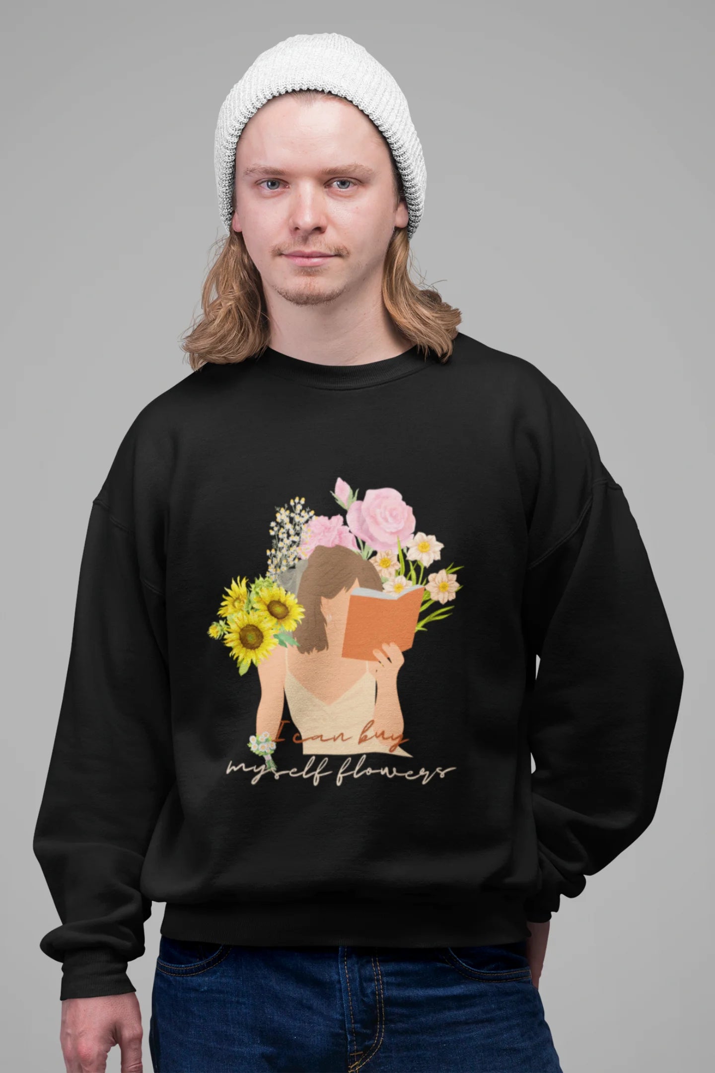 2nd front view of male model wearing a black sweatshirt with a positive message "Buy Myself Flowers" and a graphic of a smiling woman surrounded by tulips and sunflowers. Ideal for those who love inspirational clothing and floral designs.