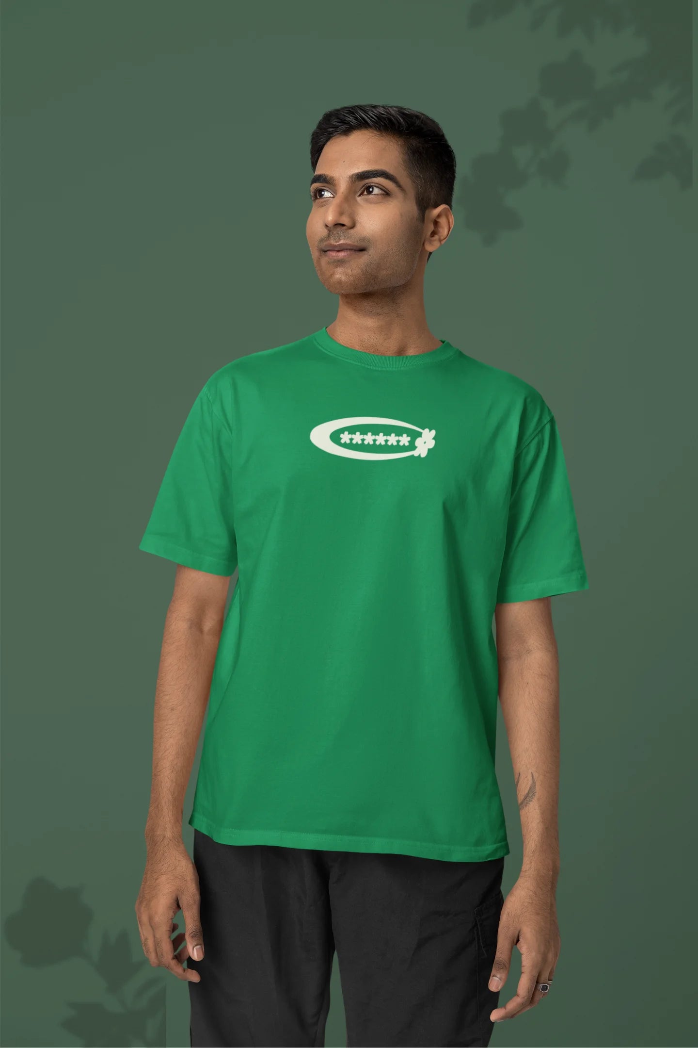 2nd front of a male model model wearing a forest green with a design featuring berry bushes overflowing with fruit, symbolizing the abundance and beauty of nature.