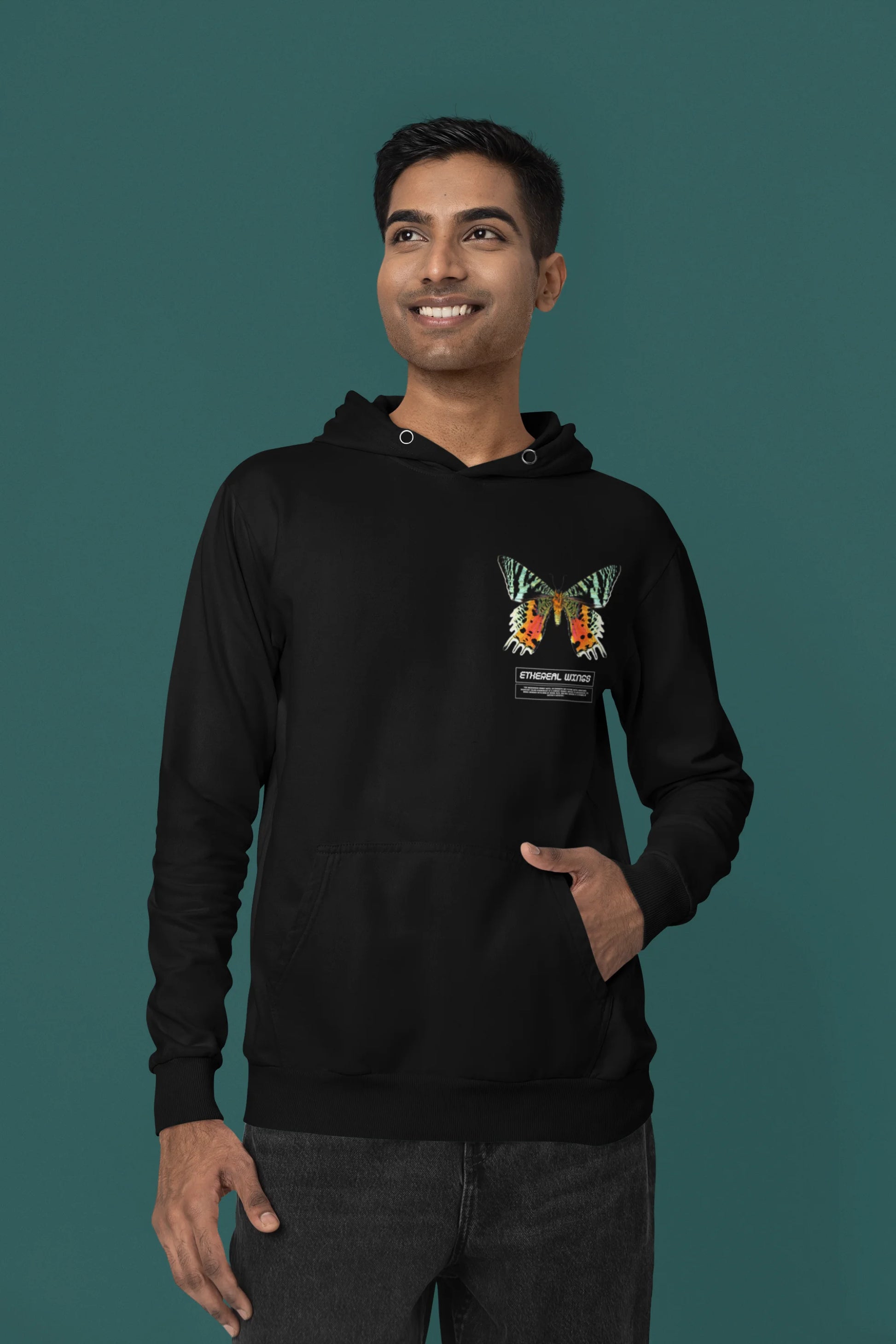 First front view of a male model wearing a black hoodie with a glowing butterfly design, symbolizing the ethereal beauty of nature.