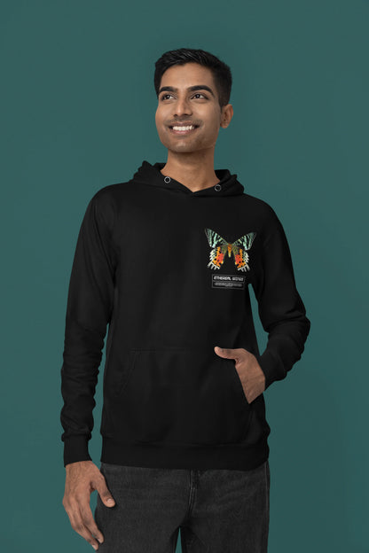 First front view of a male model wearing a black hoodie with a glowing butterfly design, symbolizing the ethereal beauty of nature.
