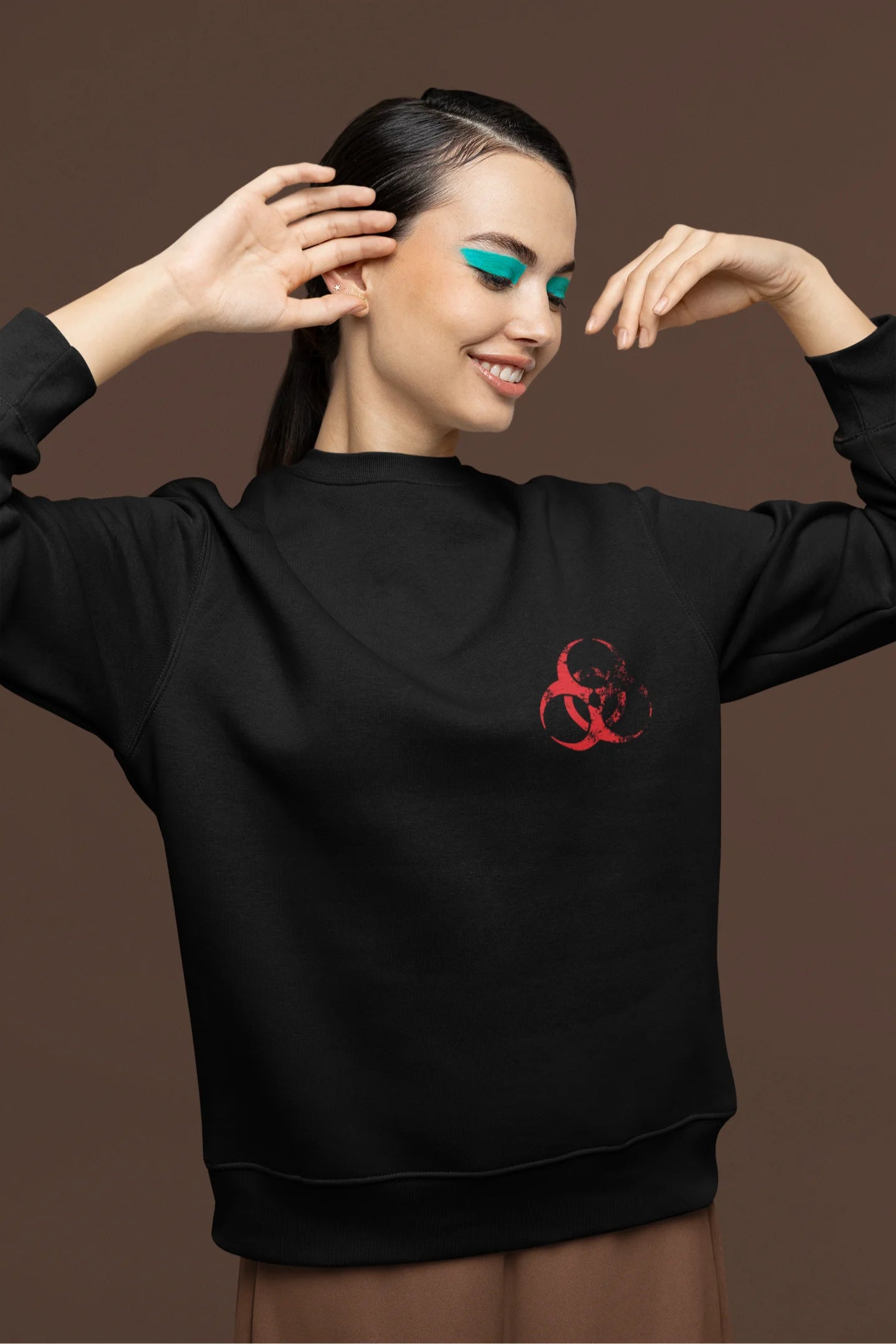 First front view of a female model wearing a black brutalist sweatshirt with a stylized, concrete-like image of an abstract statue and the word "Experiment" prominently displayed.