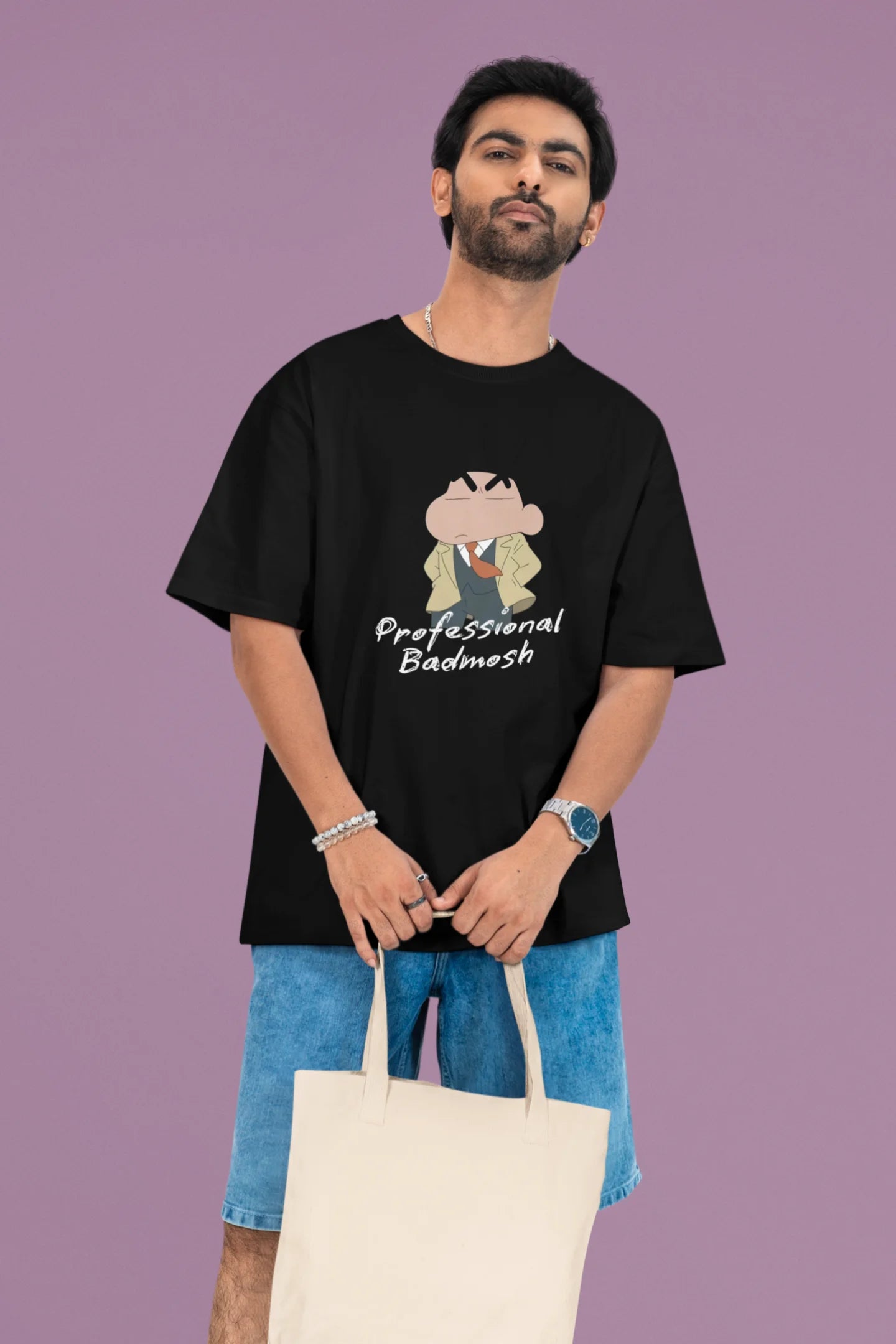 2nd front view of a male model wearing a black oversized t-shirt featuring Shinchan wearing a suit and trench coat with text saying "Professional Badmosh".