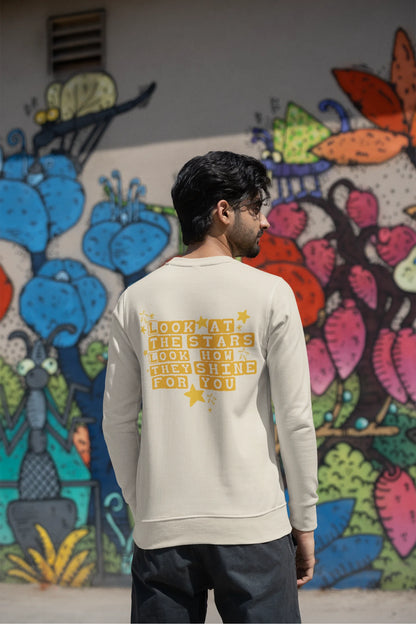 Back view of a male model wearing a cream sweatshirt with the "Yellow" album artwork by Coldplay.