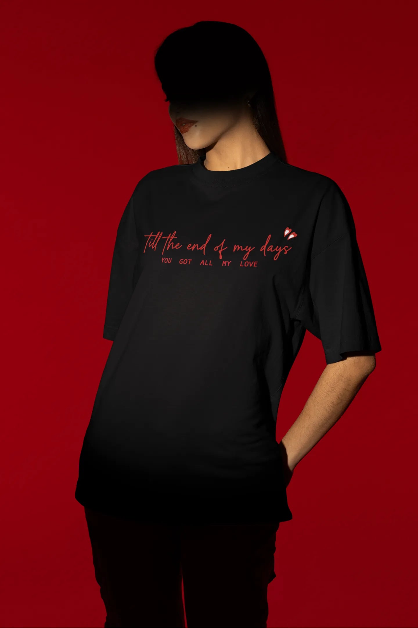Second front view of a female model wearing a black oversized t-shirt with a heart design and the text "All My Love".
