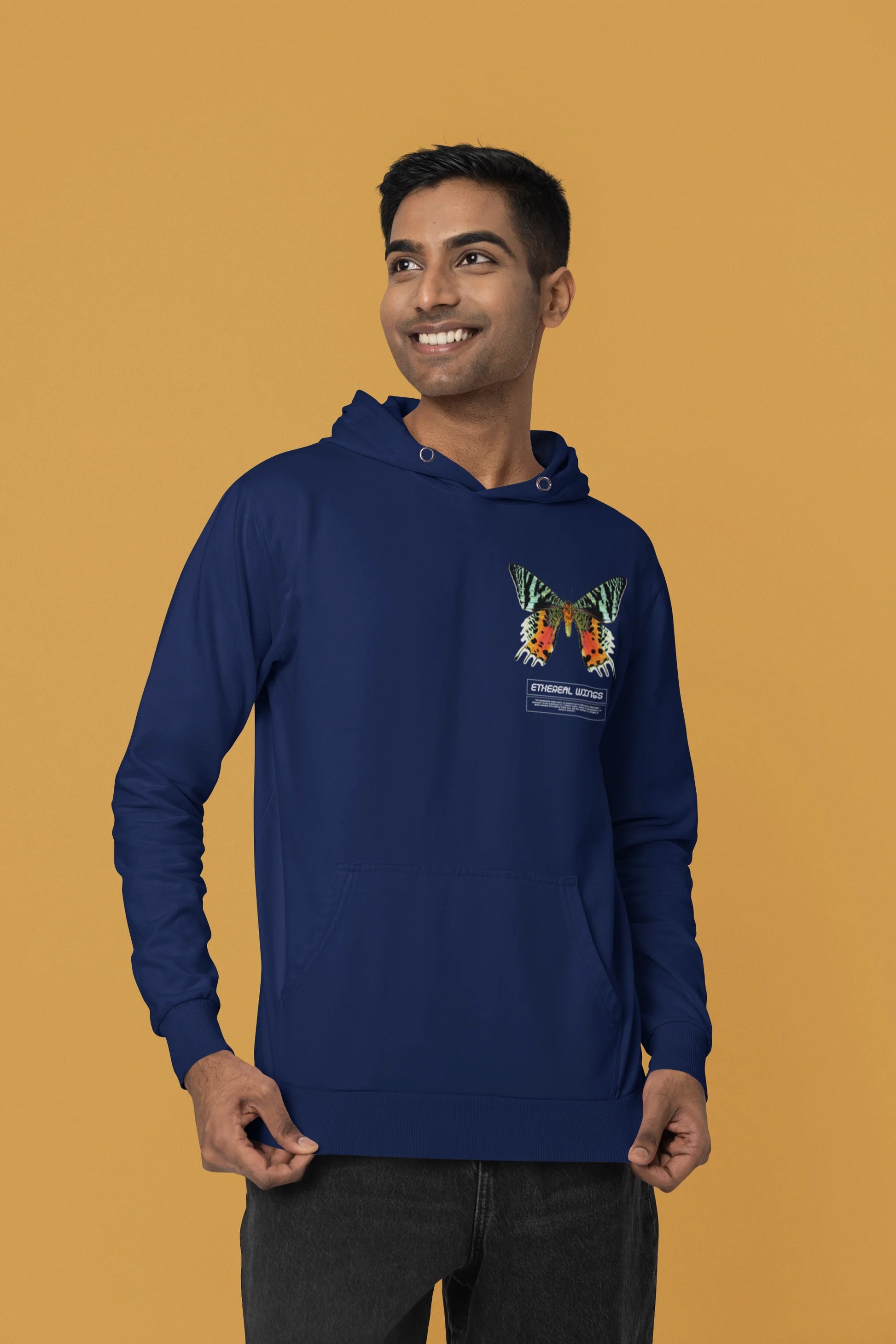 Third front view of a male model wearing a navy blue hoodie with a glowing butterfly design, symbolizing the ethereal beauty of nature.