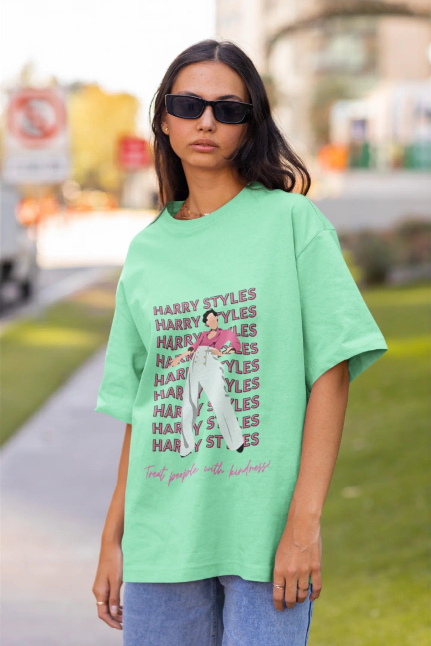 Second image of female model wearing mint green oversized t-shirt inspired by Harry Styles, featuring the 'Treat People with Kindness' mantra from the Fine Line collection.
