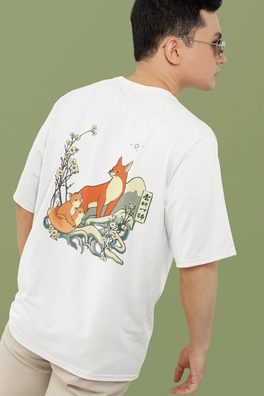 2nd back view of a male model wearing a off-white oversized tee with a design of a fox and its cub in a traditional Japanese landscape.