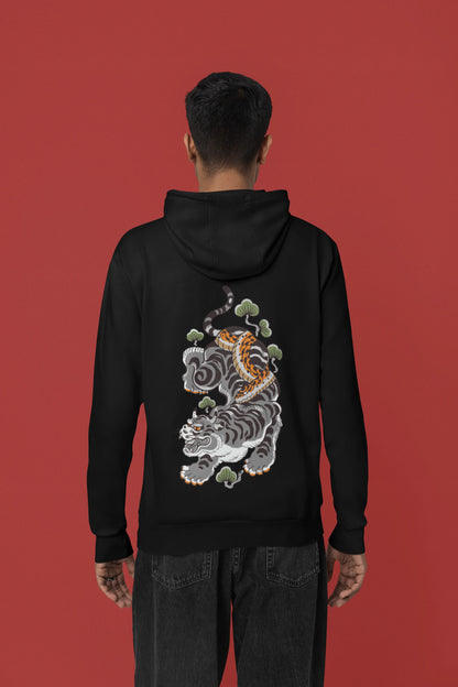 Back view of a male model wearing a black hoodie with a Japanese art style tiger design.