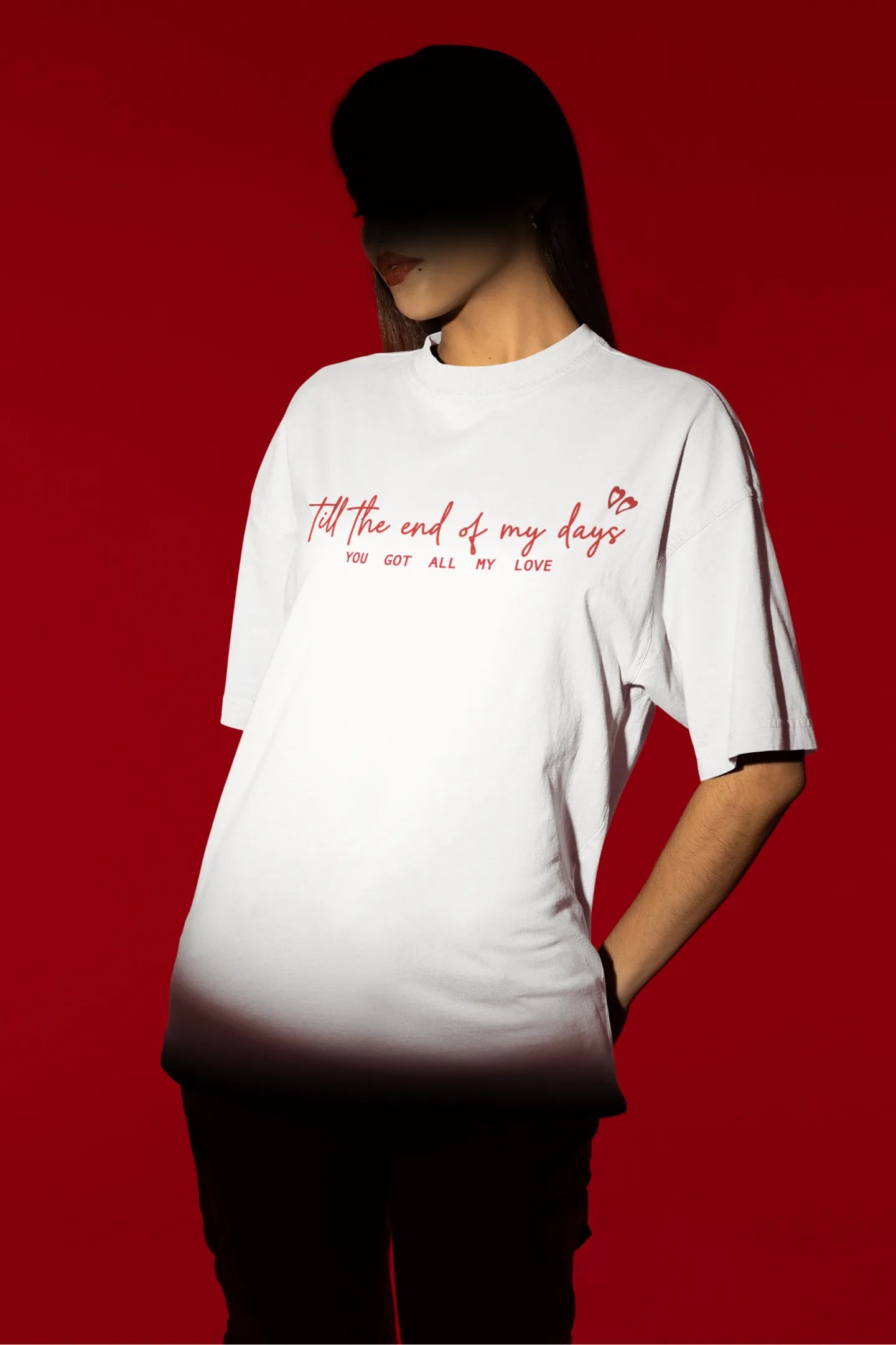 First front view of a female model wearing a off-white oversized t-shirt with a heart design and the text "All My Love".