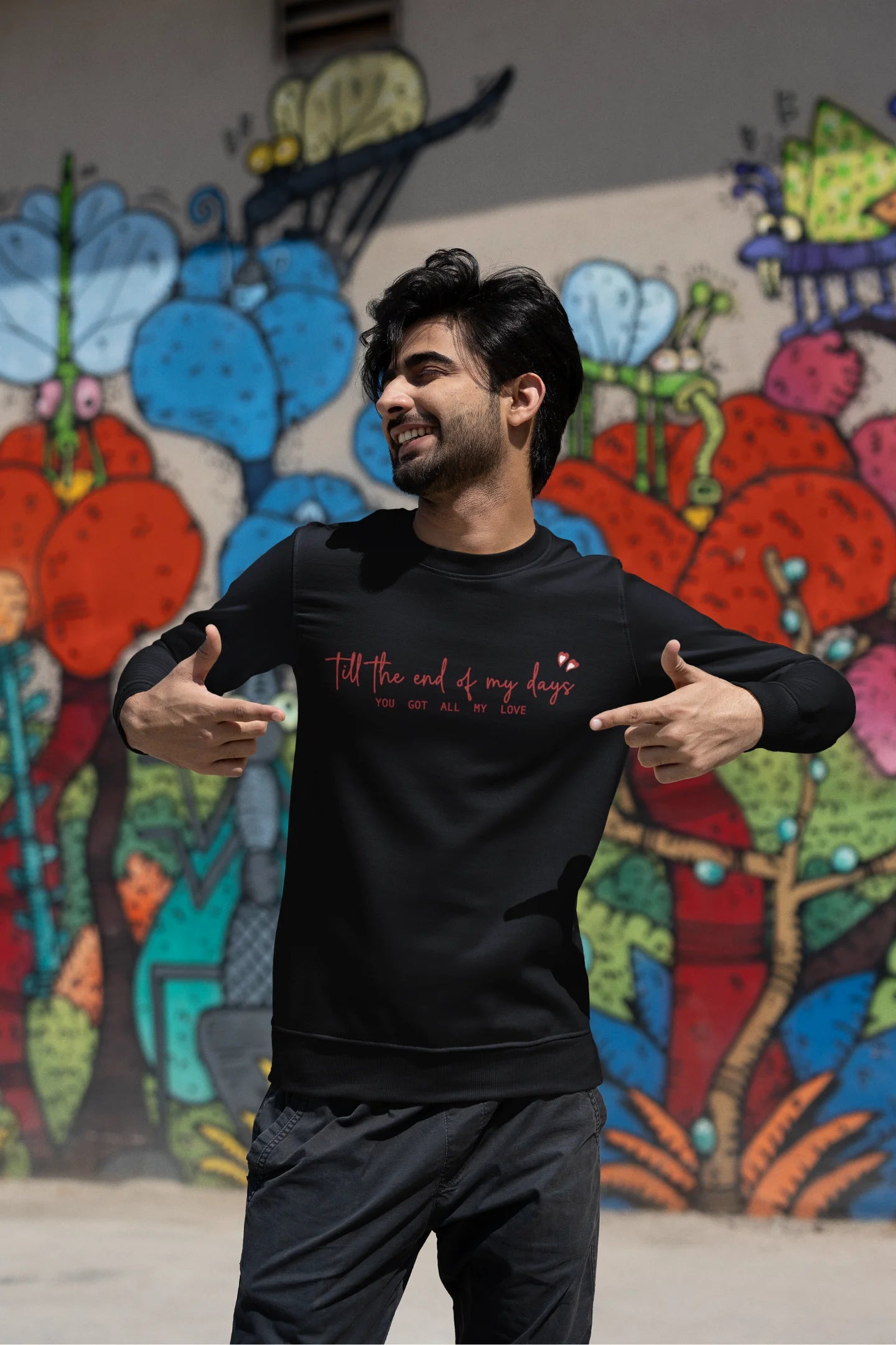 Second front view of a male model wearing a black sweatshirt with a heart design and the text "All My Love".