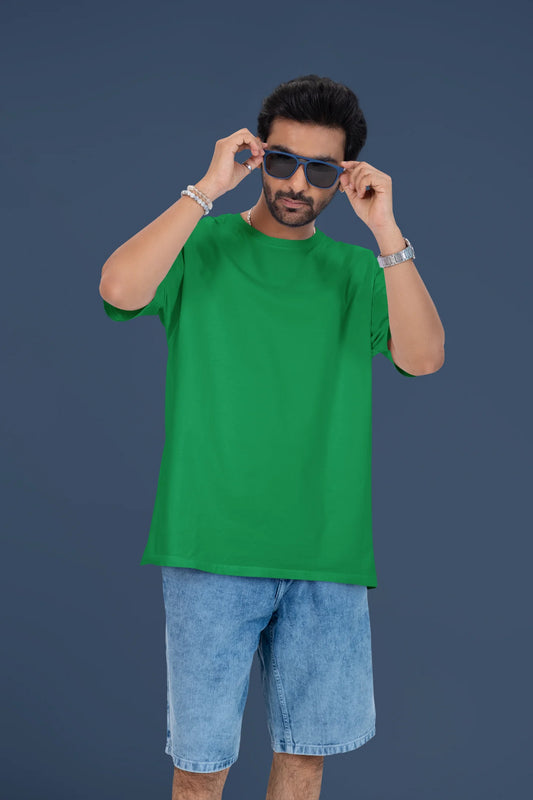 4th front view of a male model wearing a forest green oversized t-shirt featuring lyrics from Ed Sheeran's song "Perfect" against a night sky design.