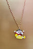 2nd view of a gold chain necklace with a small pendant depicting Shin Chan jumping in the air and shouting 
