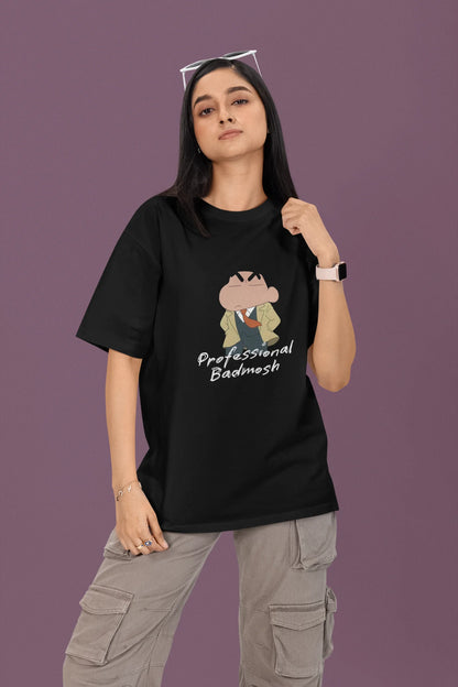 First front view of a female model wearing a black oversized t-shirt featuring Shinchan wearing a suit and trench coat with text saying "Professional Badmosh".