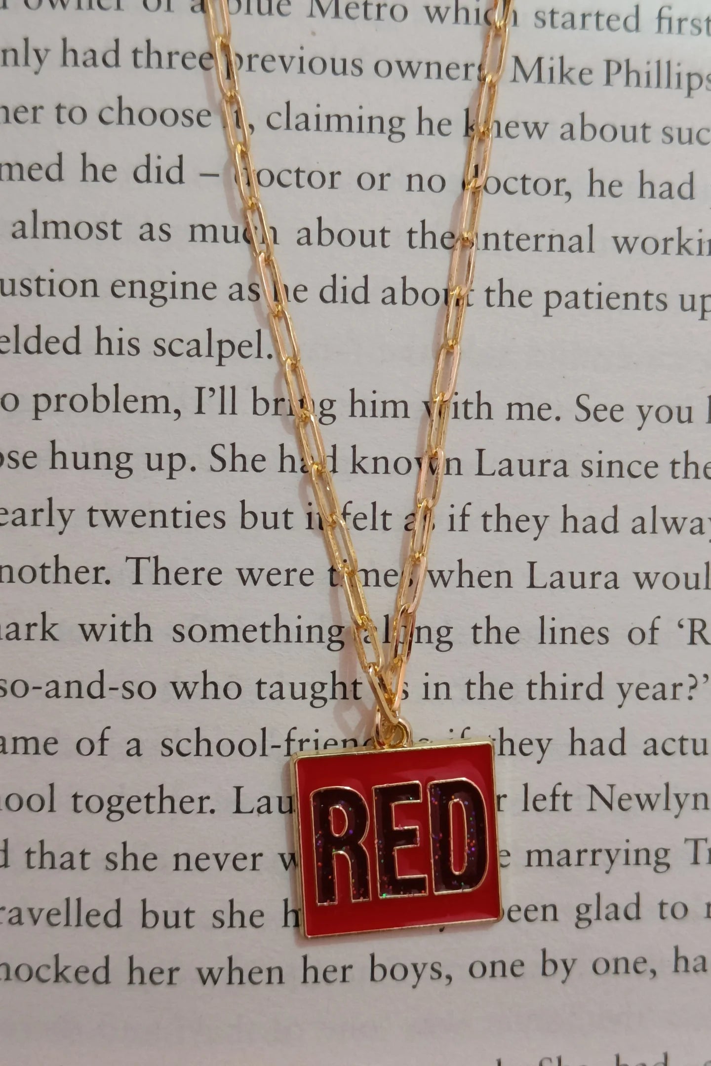 Second image of a taylor swift RED era themed anti tarnish gold chain.