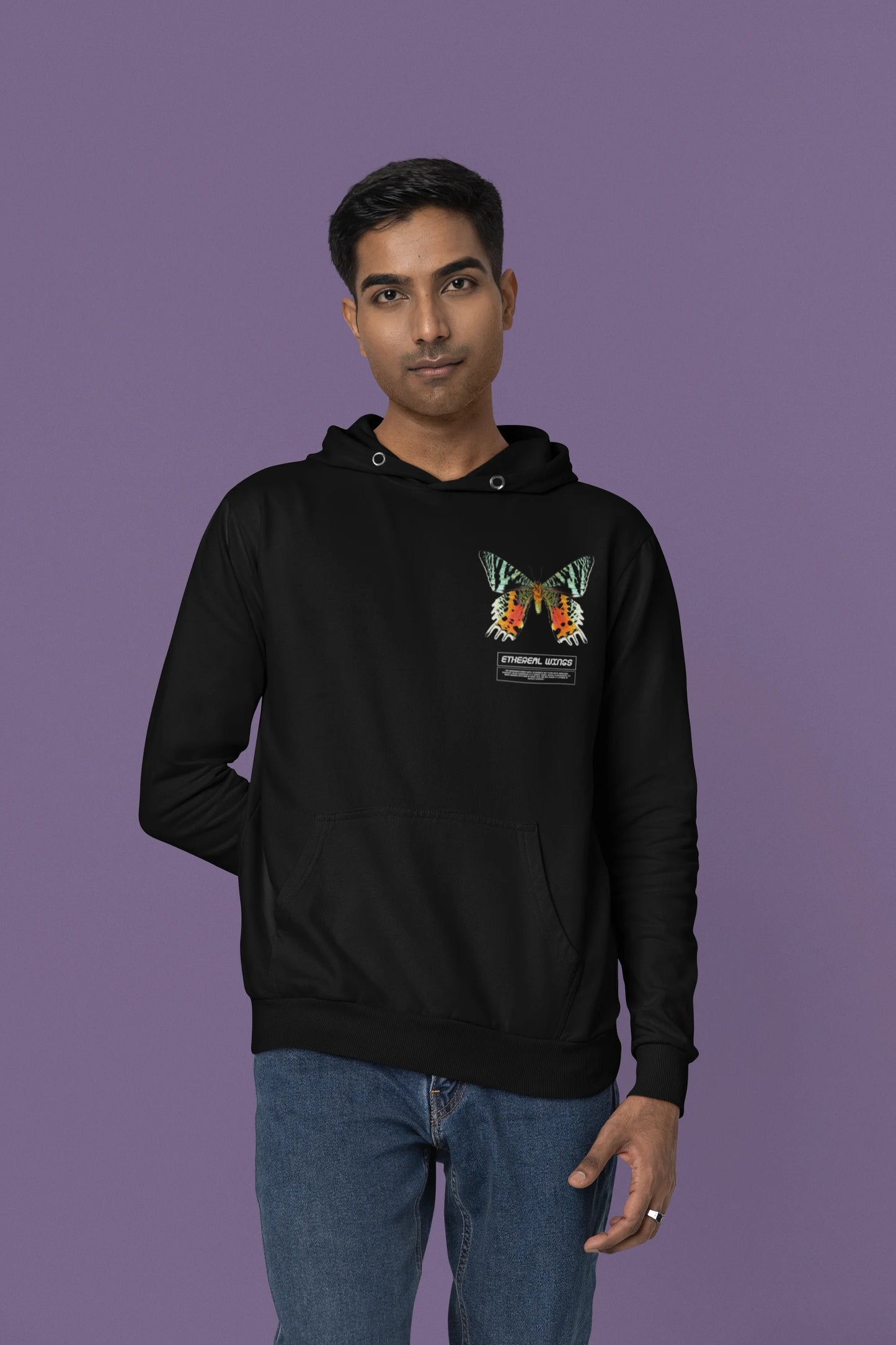Forth front view of a male model wearing a black hoodie with a glowing butterfly design, symbolizing the ethereal beauty of nature.