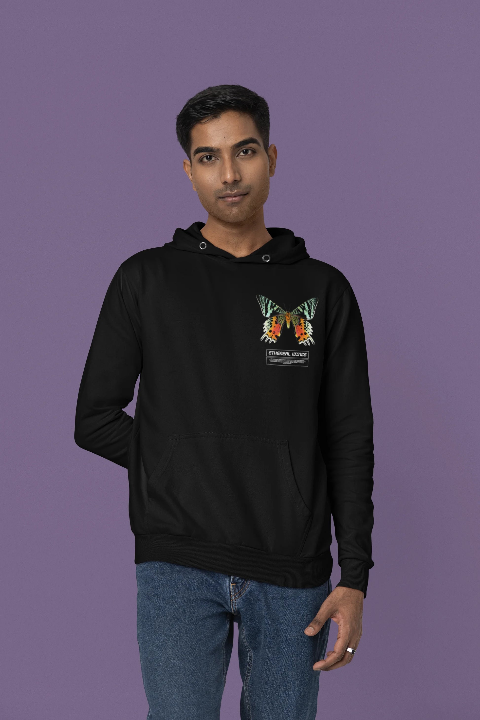 Forth front view of a male model wearing a black hoodie with a glowing butterfly design, symbolizing the ethereal beauty of nature.
