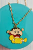 3rd view of a gold chain necklace with a small pendant depicting Shin Chan jumping in the air and shouting 