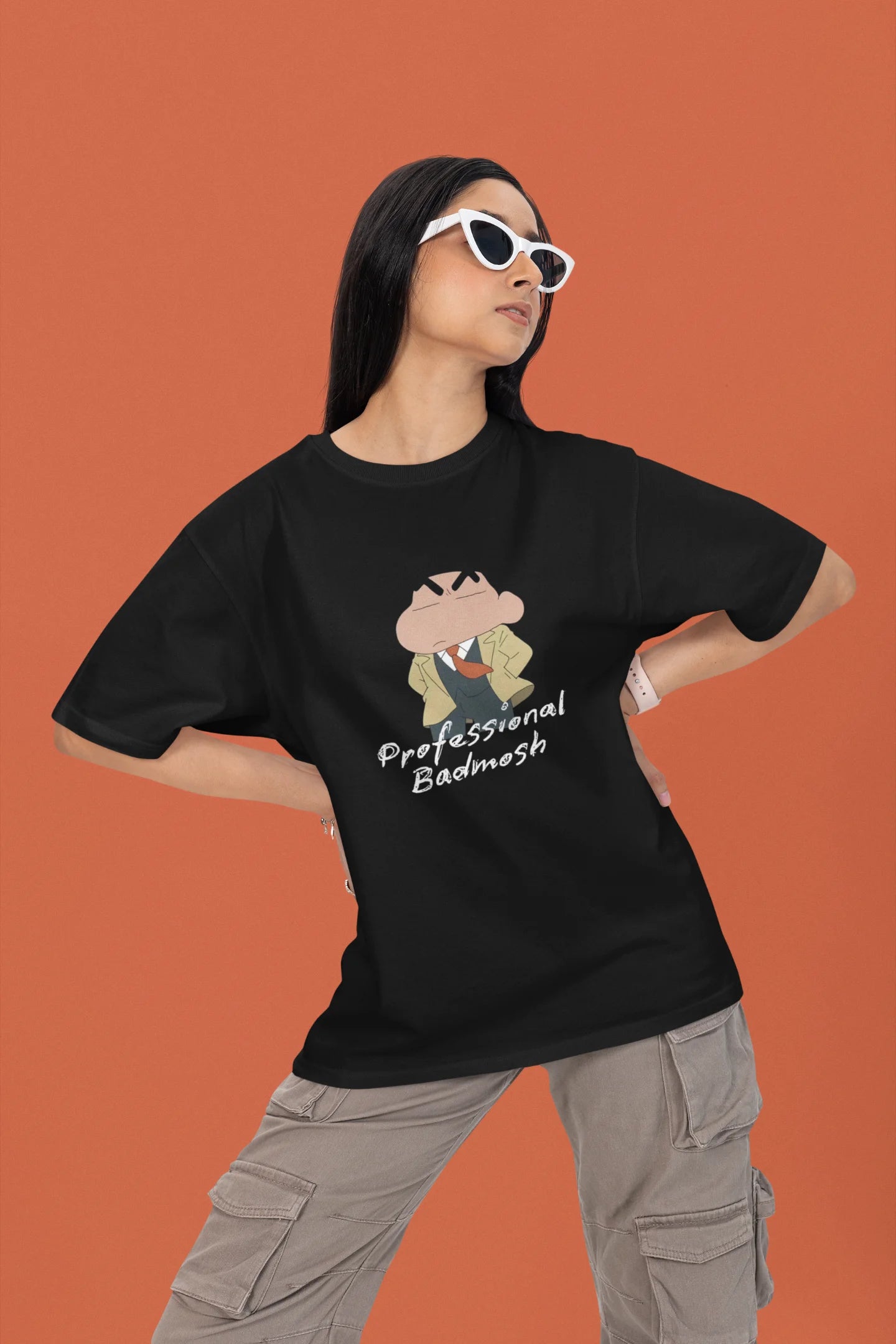 2nd front view of a female model wearing a black oversized t-shirt featuring Shinchan wearing a suit and trench coat with text saying "Professional Badmosh".