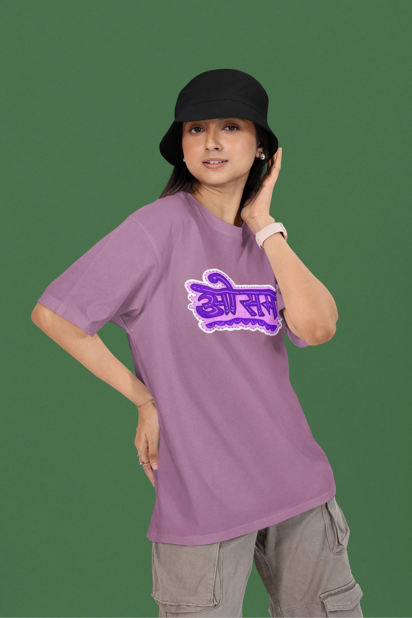 3rd front view of a female model wearing a dirty purple colored oversized graphic t-shirt featuring the word "awesome" in a Hindi script.