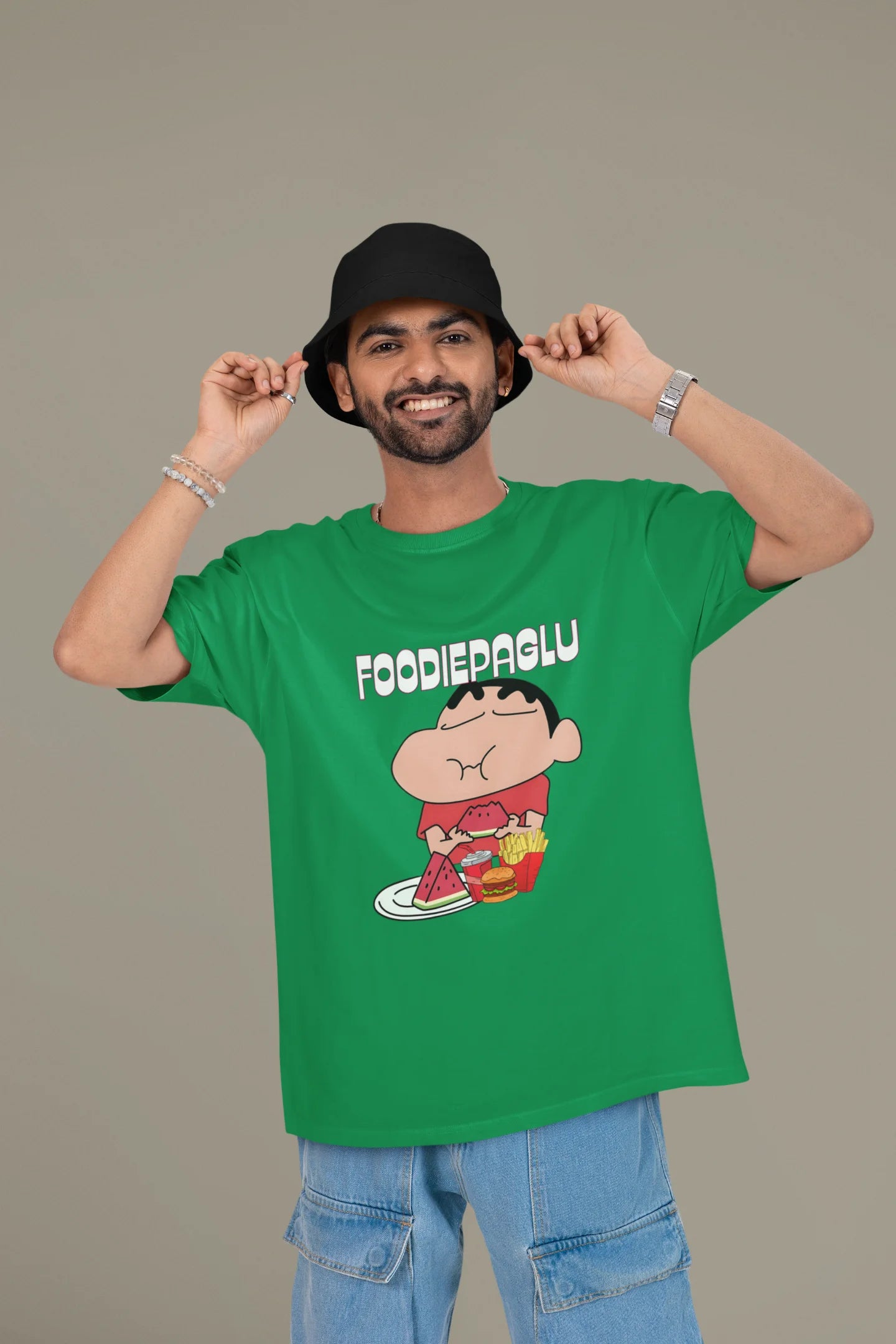 First front of a male view model wearing  a forest green oversized t-shirt featuring Shinchan eating a big meal showing his foodie side.