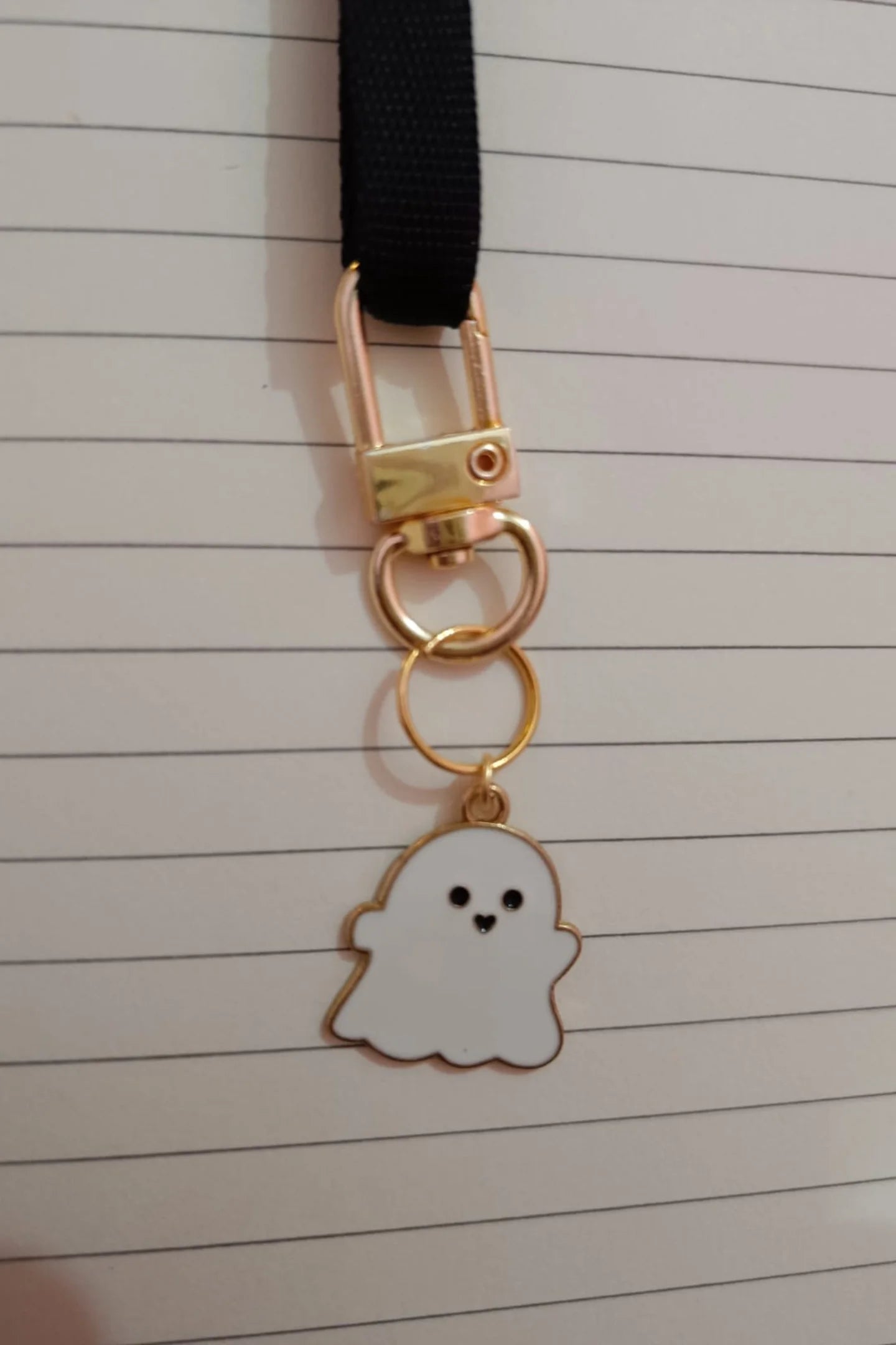 First view of white colored keychain featuring a cute spooky adorable ghost design.