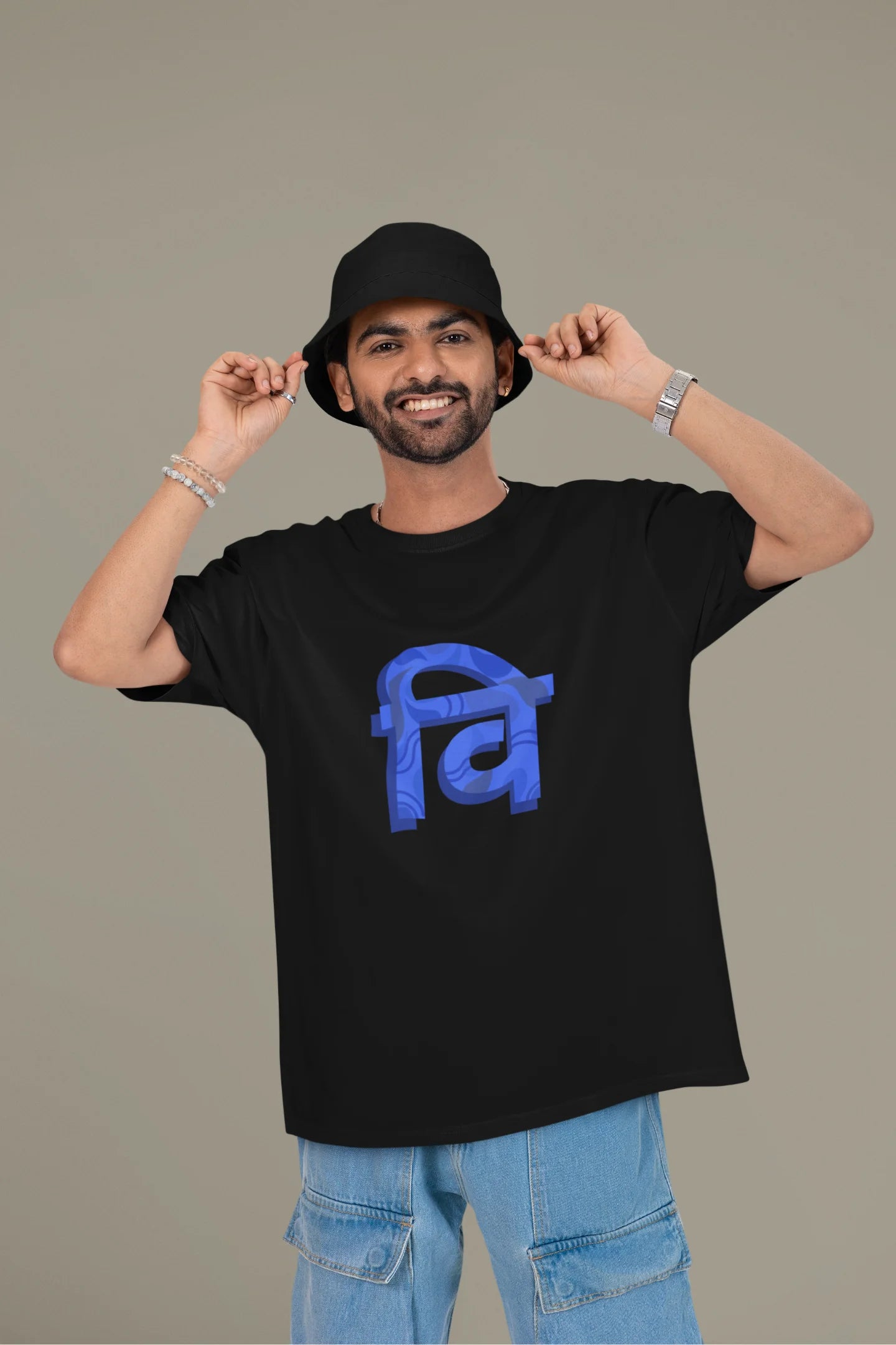 Front view of a male model wearing a black oversized tee with the phrase "Vichitra Pranee" (meaning "Strange being" or "alien") in a stylish Hindi font.